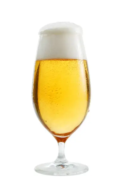 A glass of beer exposed in front of white