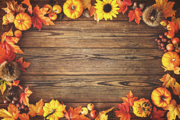 Thanksgiving autumn background Vintage autumn border from fallen leaves and fruits on the old wooden table. Thanksgiving autumn background harvest festival stock pictures, royalty-free photos & images