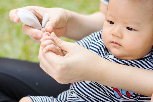 istock mother parenting baby on park 672453082