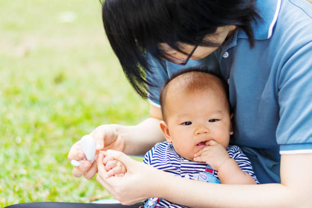 istock mother parenting baby on park 672453132