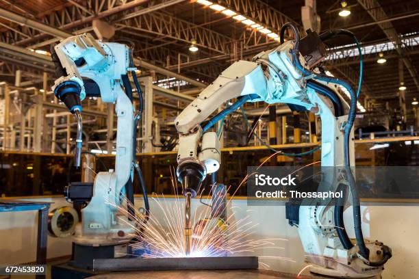 Team Robot Are Welding Assembly Automotive Part In Factory Stock Photo - Download Image Now