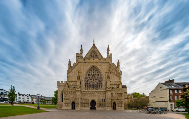 Exeter Cathedral front face in Devon Dramatic sky over the cathedral in Exeter, Devon, UK.  exeter england stock pictures, royalty-free photos & images