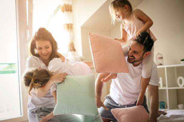 istock Happy family having fun on bed. 672459560