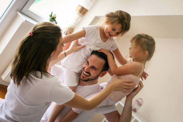 istock Happy family having fun on bed. 672459770
