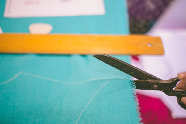 istock Seamstress woman preparing material 672460272