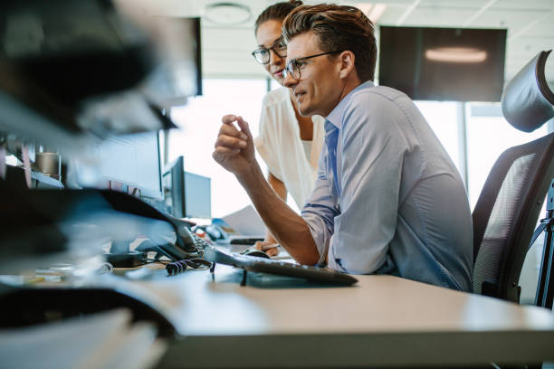 istock Business professionals looking at computer monitor 672470054