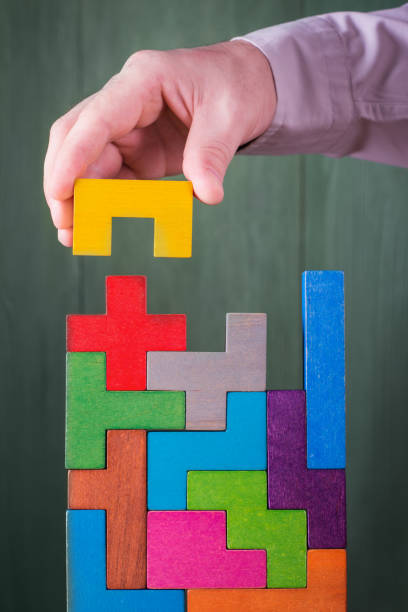 Hand with wooden toy blocks.