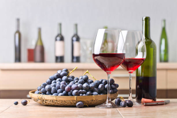 istock Bottle and glasses of red wine on the kitchen table 672477840