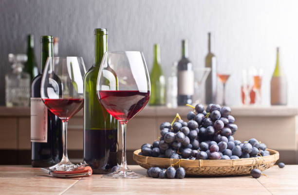 istock Bottle and glasses of red wine on the kitchen table 672477842