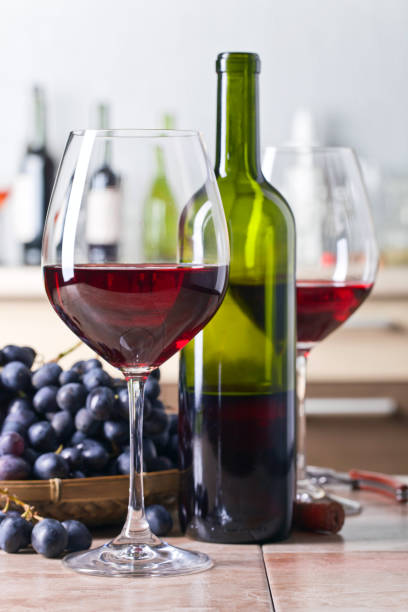 istock Bottle and glasses of red wine on the kitchen table 672477852