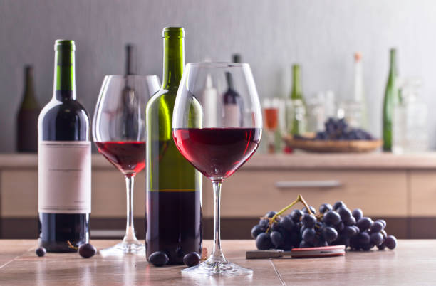istock Bottle and glasses of red wine on the kitchen table 672477860