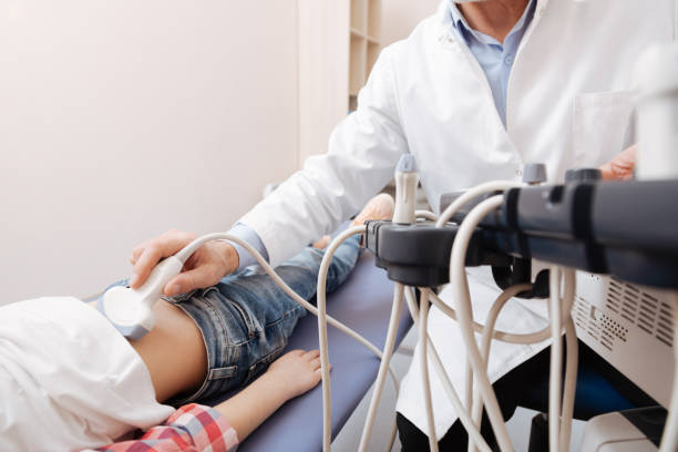 istock Competent sonographer examining patient abdomen in the clinic 672478276