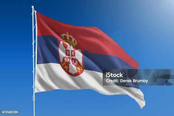 National Flag Of Serbia On Clear Blue Sky Stock Photo - Download Image Now - Serbia, Flag, Serbian Flag