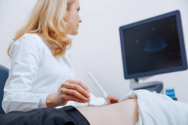istock Charming young physician having appointment at the sonography cabinet 672483082