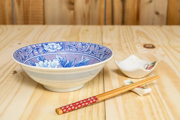 istock Chopsticks, Holder, Sauce bowl and Bowl on a Pine Table 672486636