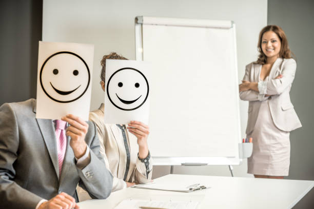istock Business team holding happy smile sign 672487284