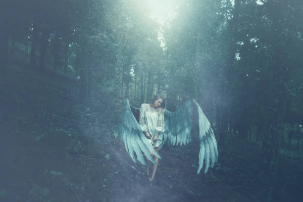 istock fallen angel in the forest 672495296