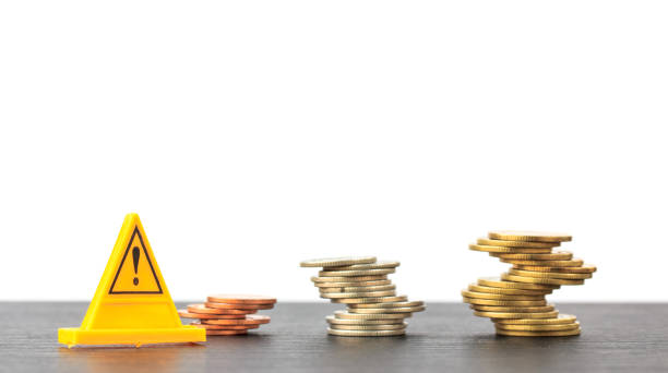 istock Risky coin stack and Warning label on white background.Financial crisis concept. 672496256