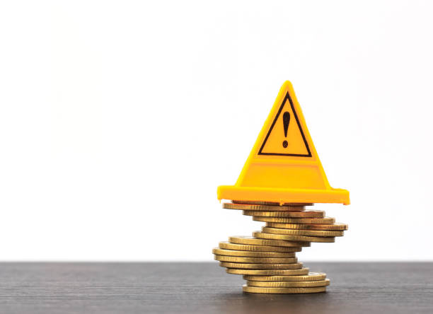 istock Risky coin stack and Warning label on white background.Financial crisis concept. 672496258