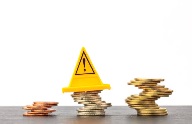 istock Risky coin stack and Warning label on white background.Financial crisis concept. 672496260