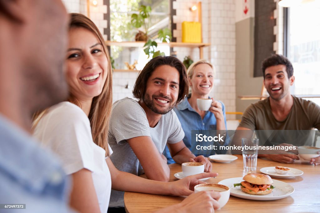 Group Of Friends Meeting For Lunch In Coffee Shop Friendship Stock Photo