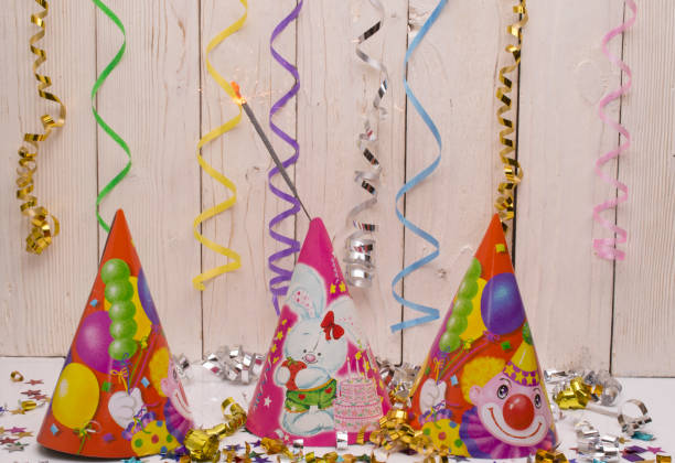 istock Greeting card for carnival party. hat and candles on white background. 672497536