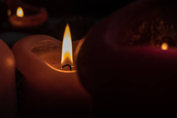 istock Candles burning at night. Candle light  on black background 672497774