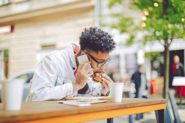 Young man having lunch in the city