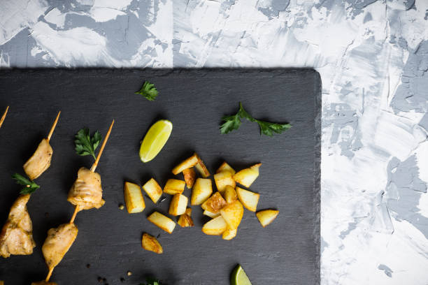 istock Chicken kebab on the black stone background 672502262