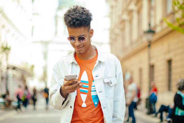 istock Young man using phone in the city 672506116