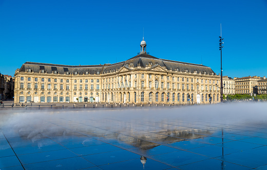 Water mirror fountain and Palais de la Bourse in Bordeaux - France