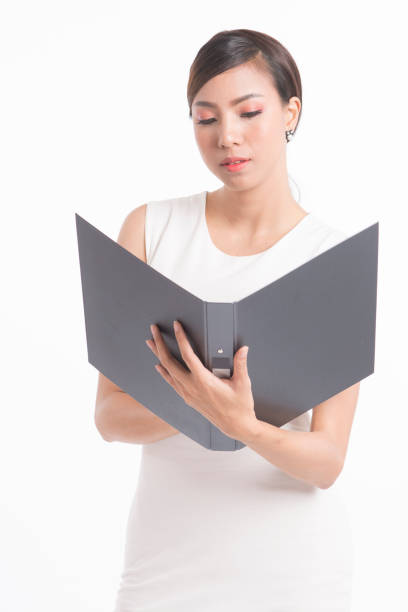 istock Business woman standing and holding file 672506668