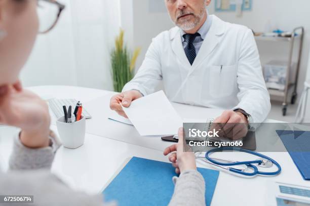 Doctor Giving A Prescription Stock Photo - Download Image Now - Doctor, Prescription Medicine, Prescription