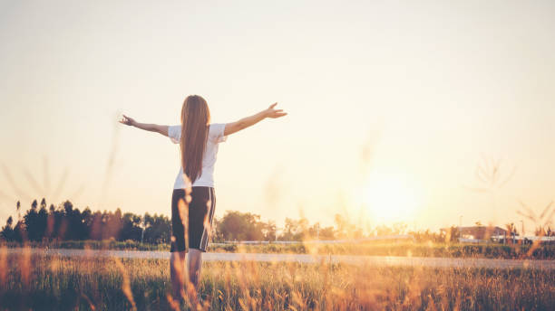 istock Young woman raise hands up for her success 672507026