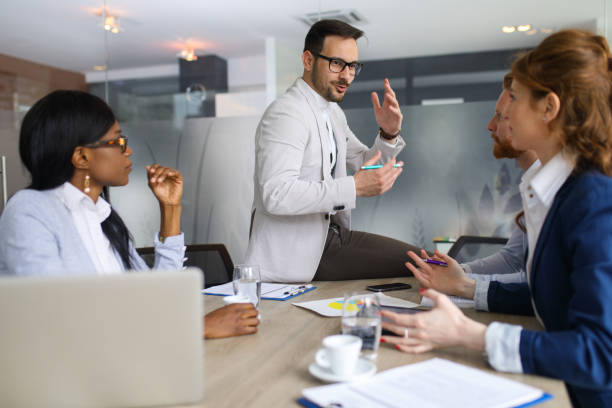istock Young businessman discussing sale analysis with colleagues 672514658