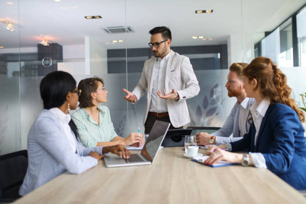 istock Businessman explaining business plan to coworkers 672517446