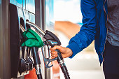 Man picking up fuel nozzle