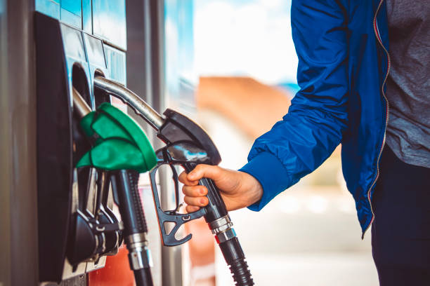 Man picking up fuel nozzle Male hand holding fuel pump nozzle, Diesel Fuel, Car, station stock pictures, royalty-free photos & images