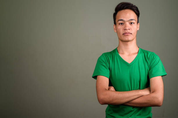 istock Studio shot of young Asian man against colored background 672528390