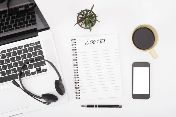 istock computer headset and coffee cup with to do list on desk from above, planning and schedule concept. 672530584