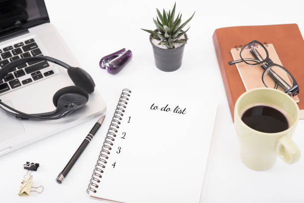 istock computer headset and coffee cup with to do list on desk from above, planning and schedule concept. 672530632