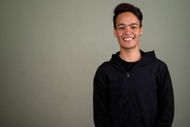 istock Studio shot of young Asian man against colored background 672531870