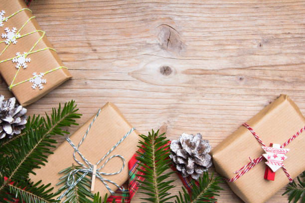 istock Christmas presents on wooden background, retro style with copy space 672533794