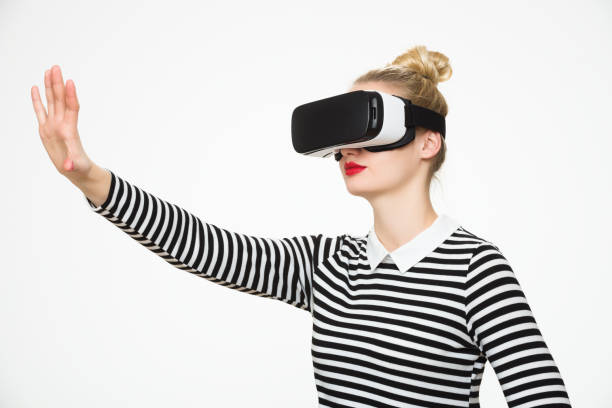 istock Woman wearing virtual reality glasses. VR headset. Virtual reality concept 672534848