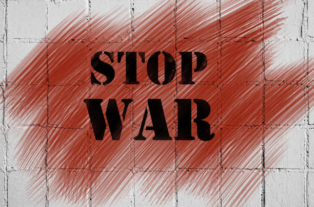 istock The inscription on the brick wall is a stop war. On abstract blood smeared 672539036
