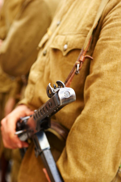 istock Unidentified re-enactor dressed as Russian Soviet soldier with machine gun 672541284