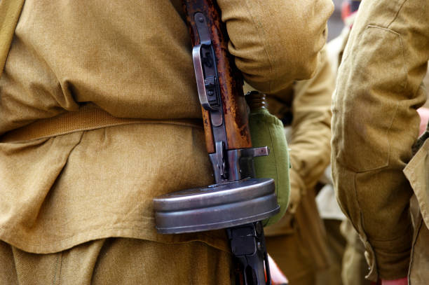 istock Unidentified re-enactor dressed as Russian Soviet soldier with machine gun 672541348