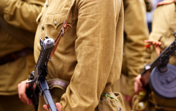 istock Unidentified re-enactor dressed as Russian Soviet soldier with machine gun 672541362