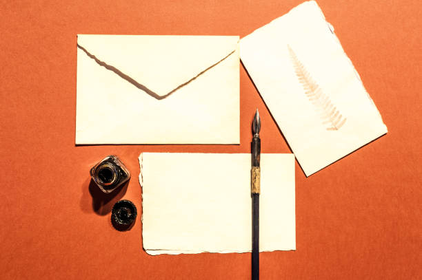 istock Fountain pen, ink well and letter on orange background 672546362