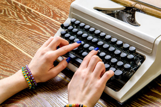 istock Girl working at contemporary typing machine 672546628